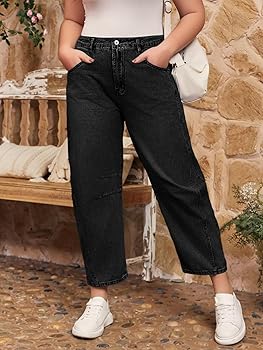 Close-up of plus-size barrel jeans tapered hem ending above pointed-toe black ankle boots