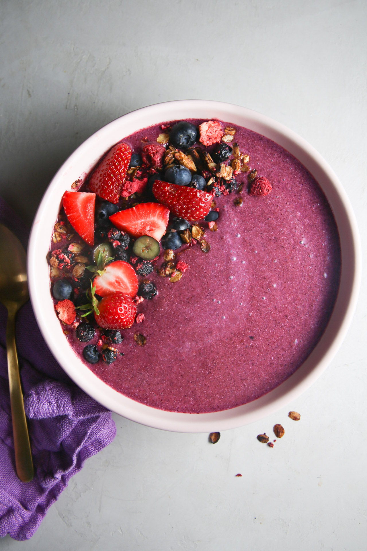 Gorgeous smoothie bowl topped with berries granola and nut butter