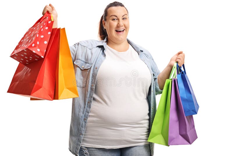 Happy plus size woman with multiple shopping bags in bright shopping district