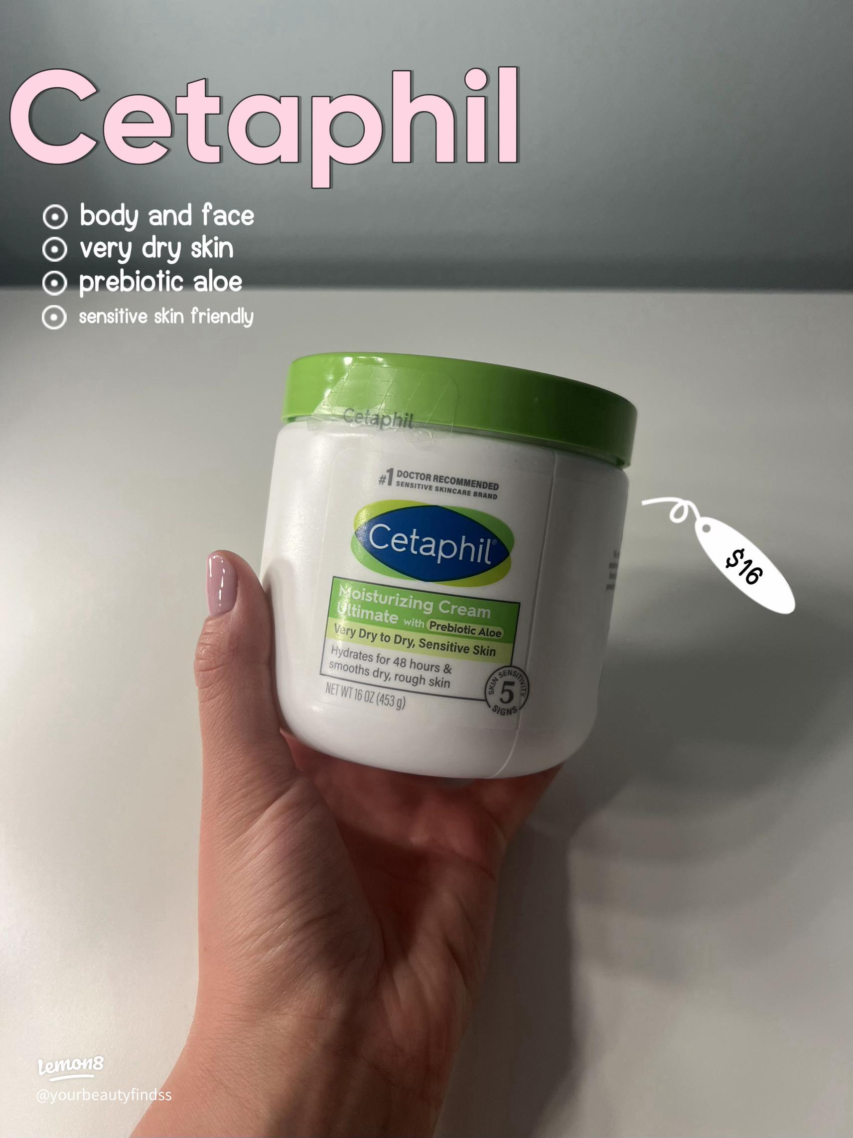 Open Cetaphil Moisturizing Cream tub with a swipe of the thick cream across a glass surface