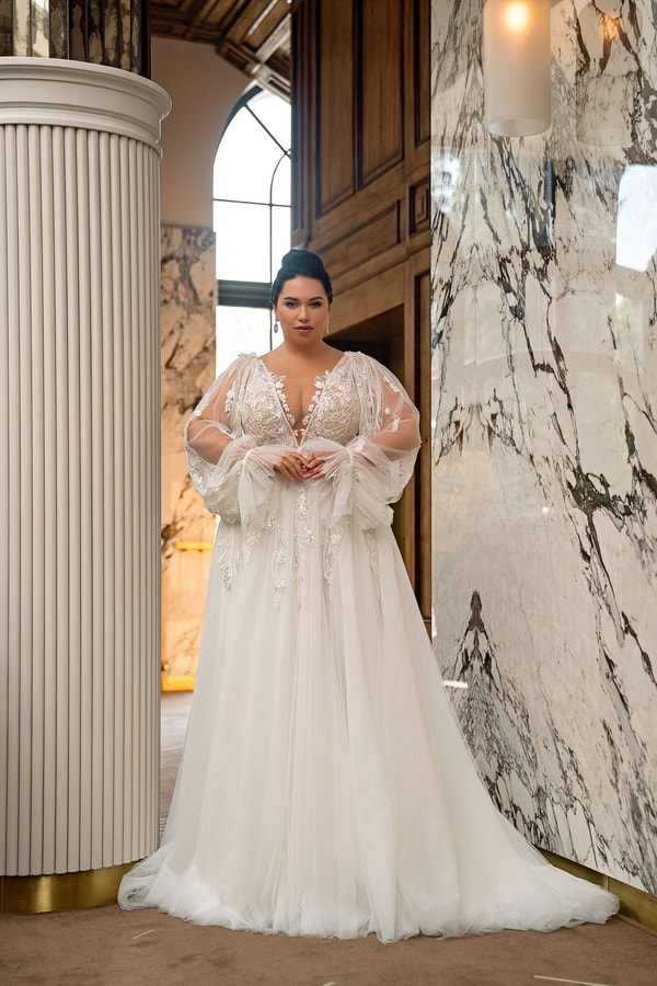 Plus-size bride in a premium designer wedding dress in the 2500 to 5000 dollar tier