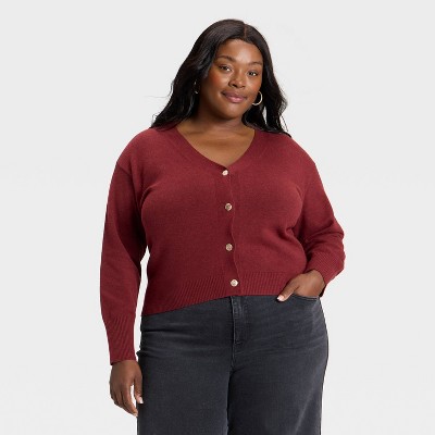 Plus-size candidate in burgundy ponte sheath and camel cardigan for healthcare admin interview