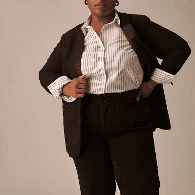 Plus-size candidate in navy sheath and cream blazer for a final-round executive interview