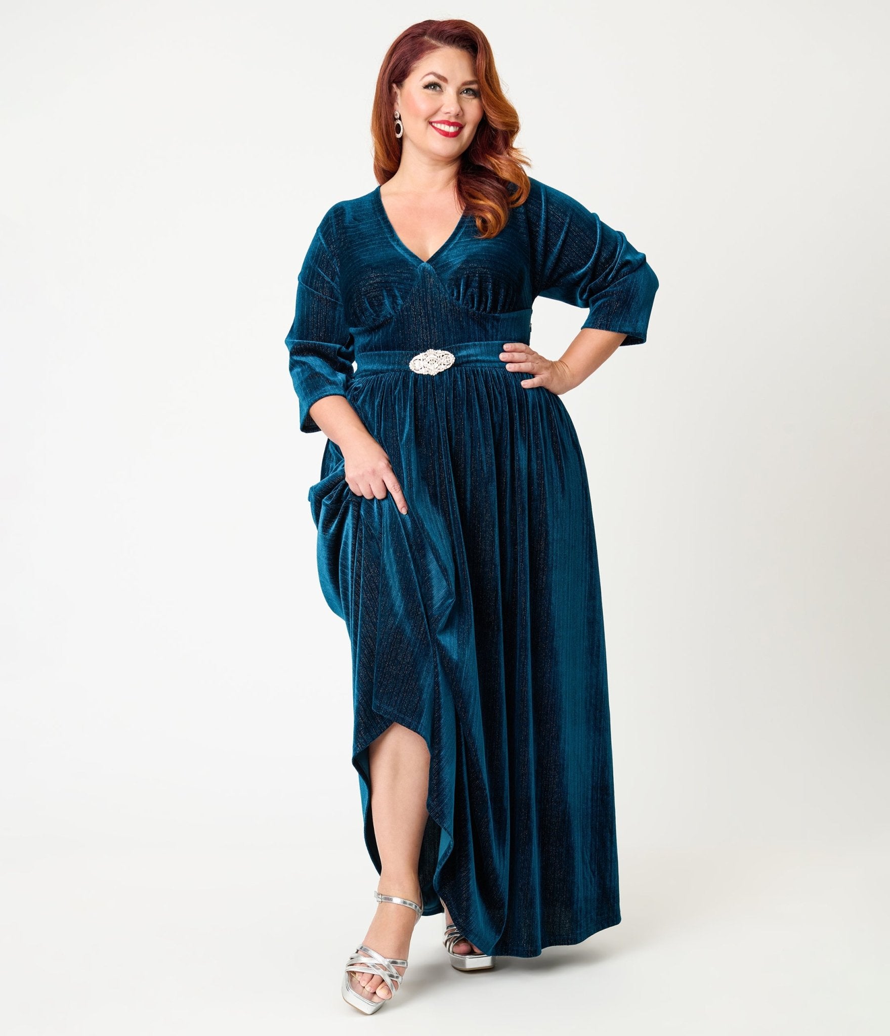 Plus-size guest in deep teal velvet long-sleeve midi dress for winter wedding