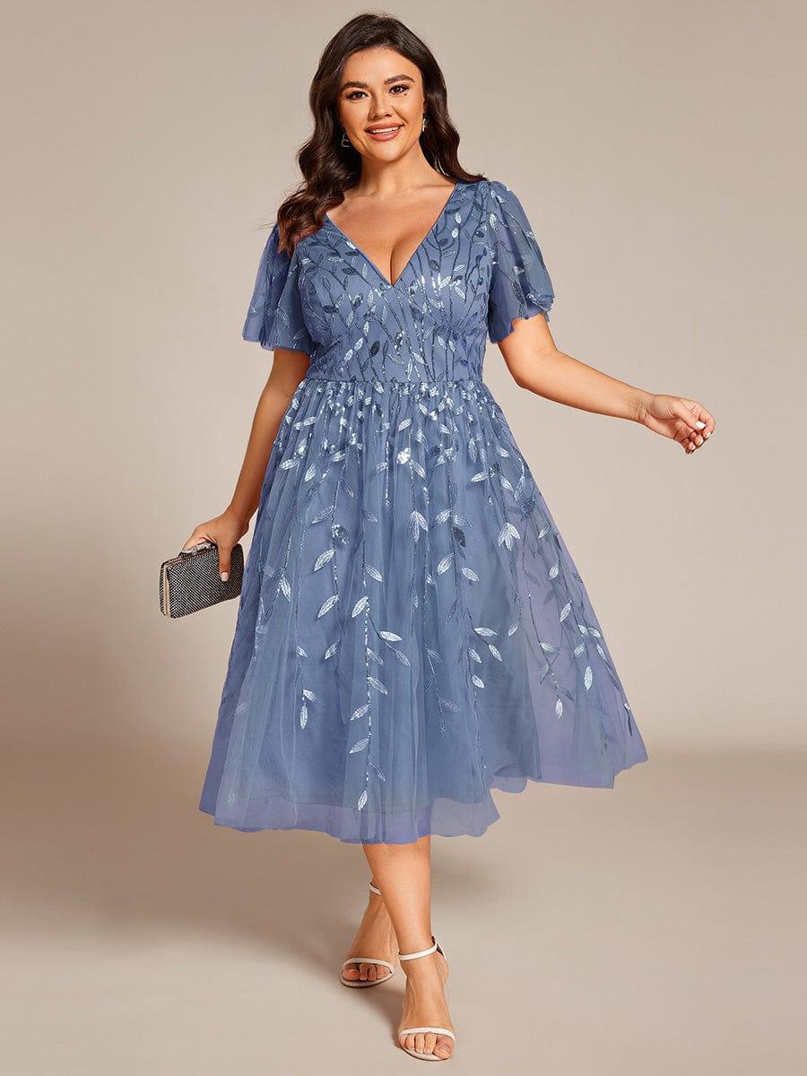 Plus-size guest in navy beaded midi dress for formal wedding