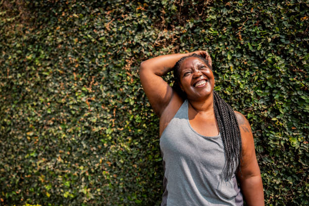 Plus-size woman doing a peaceful standing side stretch in a sunlit living room