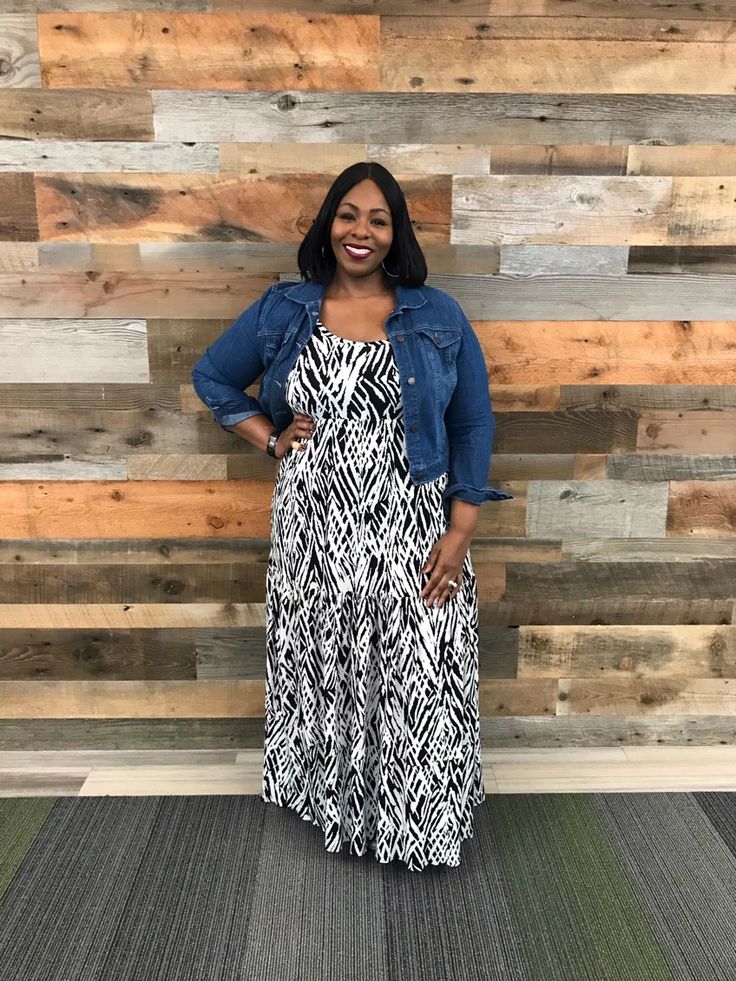 Plus-size woman looking stylish in a denim jacket and floral dress