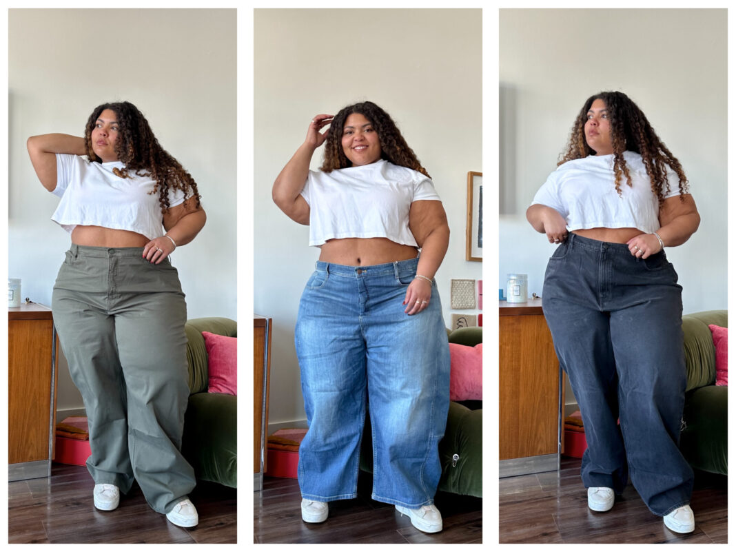 Plus-size woman wearing dark wash barrel jeans, fitted white tank, and pointed boots in editorial street-style shot