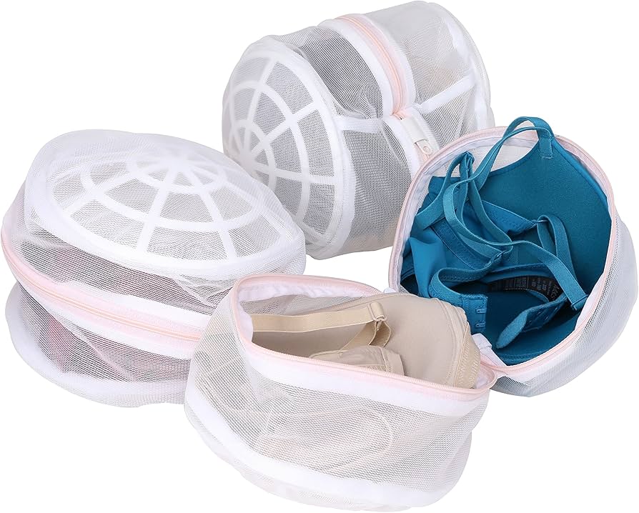 Three Elomi Cate bras in different colors folded next to a mesh lingerie wash bag