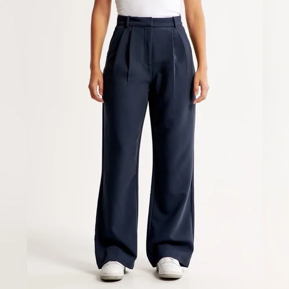 Banana Republic Curvy Sloan Pant in navy on a plus size frame with silk blouse and pumps