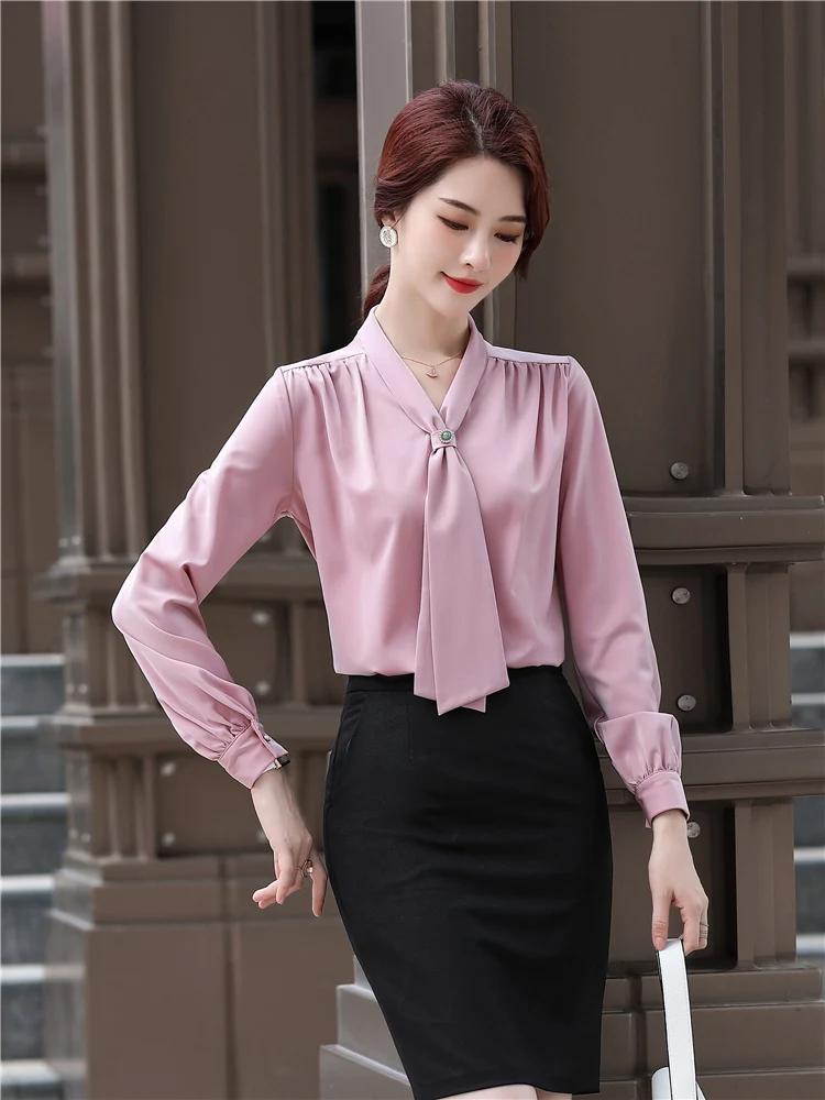 Loft Plus bow neck blouse in blush pink on a plus size body with pencil skirt