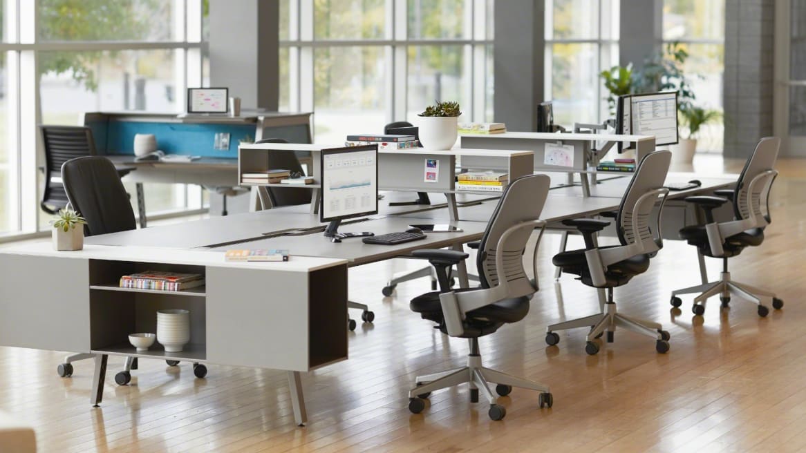 Four heavy-duty plus-size and bariatric office chairs side by side - Steelcase Leap V2, ErgoElements Big and Tall, HON Endorse, and Concept Seating 3142R1 - in a showroom comparison