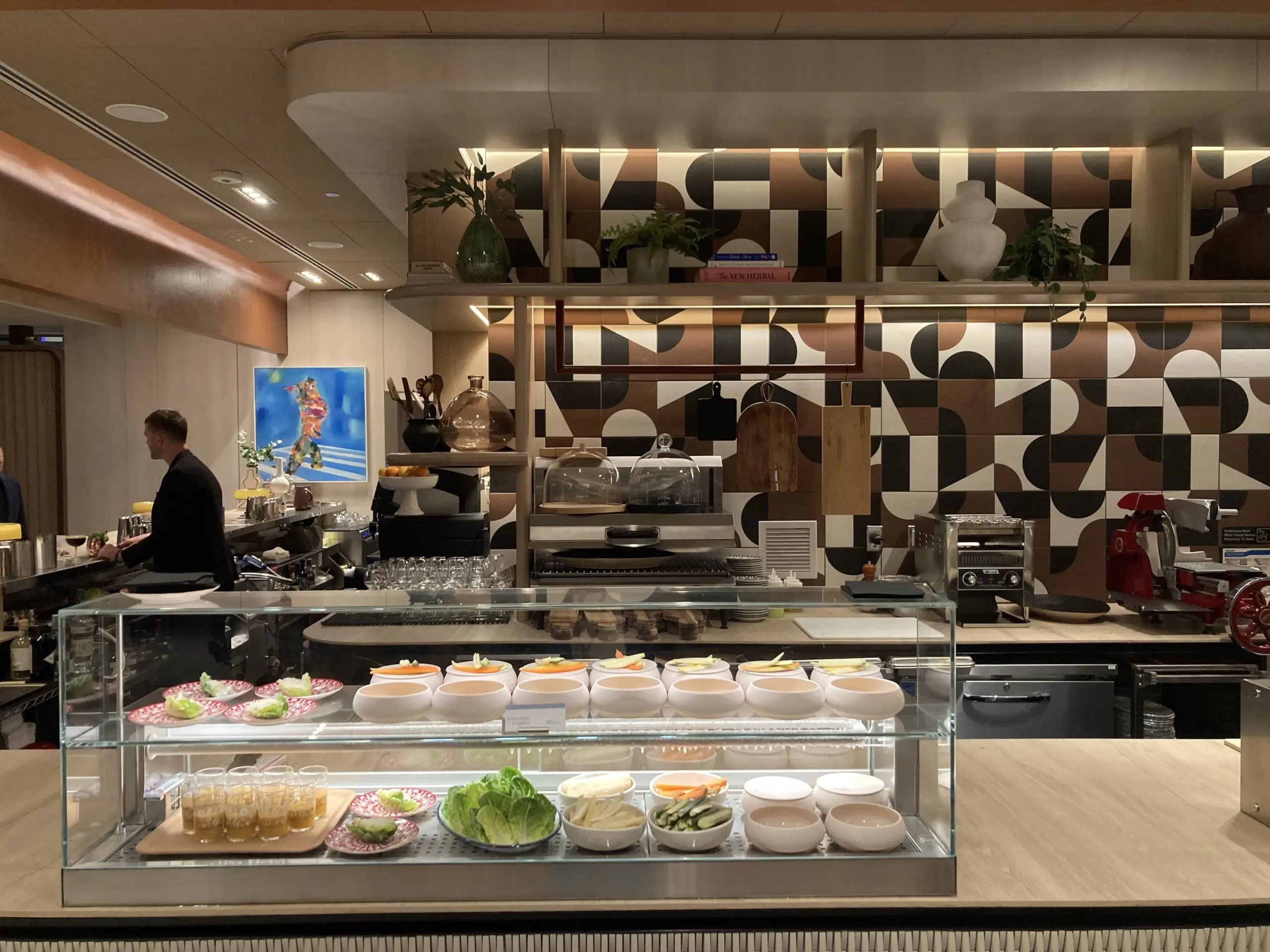 airport lounge buffet station with staff plating food