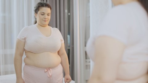A joyful plus-size woman celebrating at the end of her mirror confidence challenge