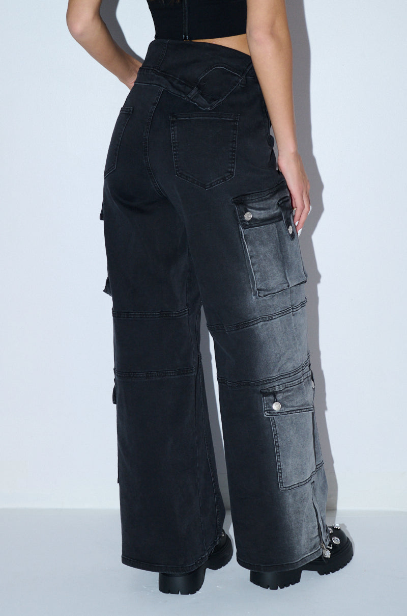 A pair of dark high-waisted jeans folded to show the inner waistband construction
