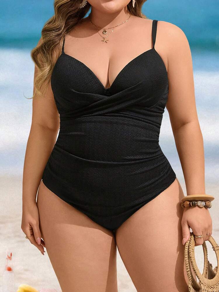 A plus-size woman swimming in a supportive dark one-piece swimsuit