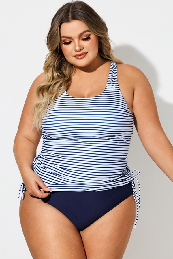 A plus-size woman wearing a long-line tankini top and swim bottoms
