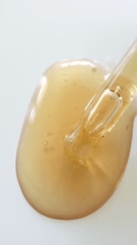 Close-up of retinol serum dropper showing product texture