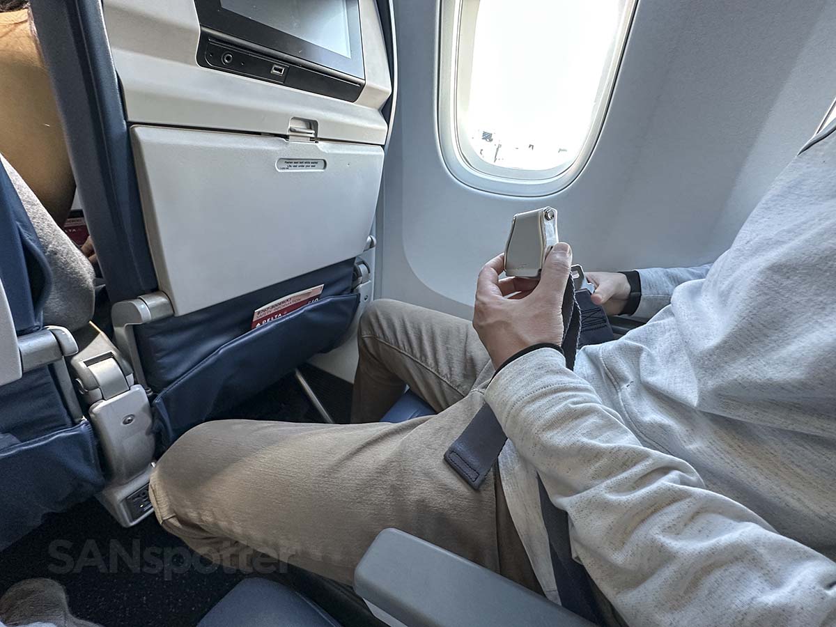 Delta Airlines economy cabin seats with seatbelts visible