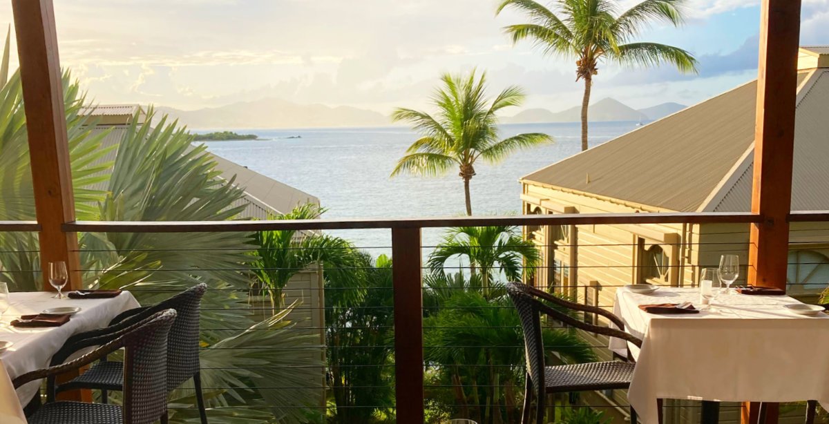 Elegant resort restaurant terrace with Caribbean ocean view at sunset