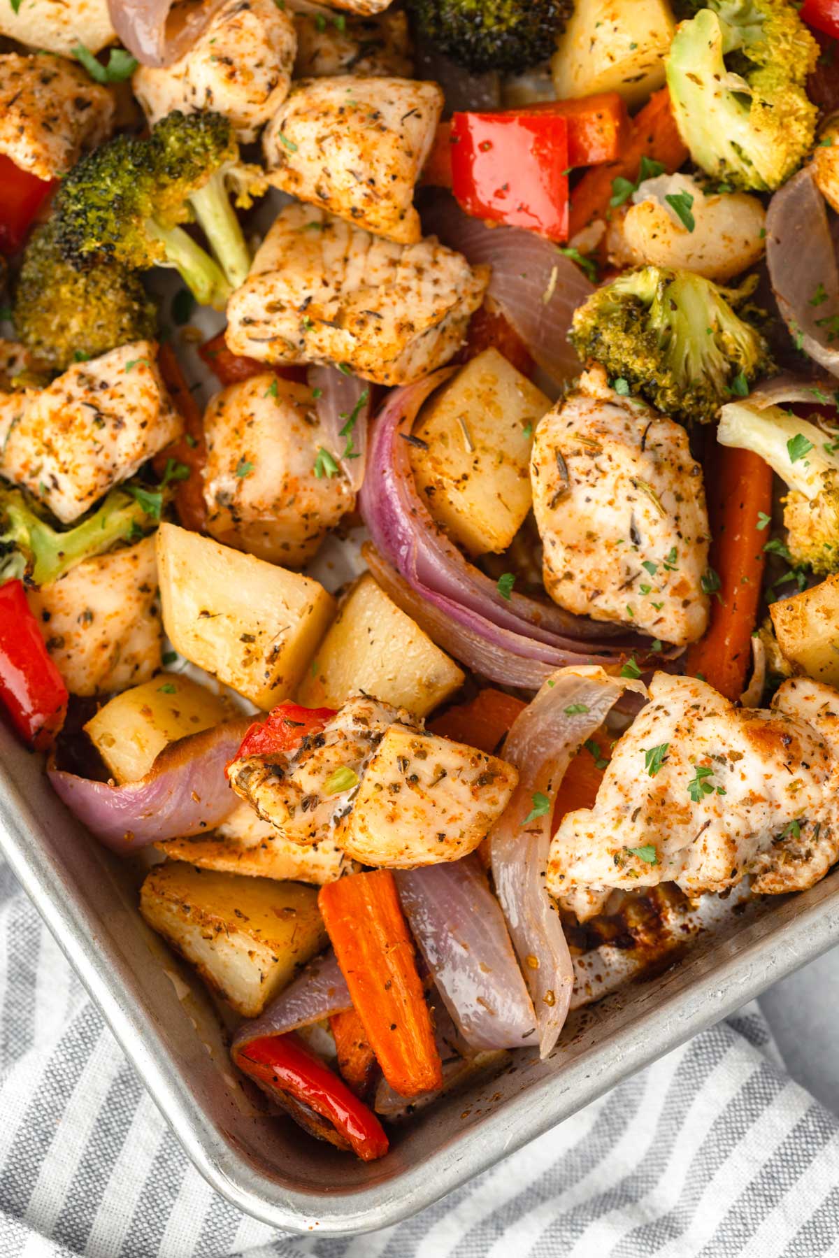 Golden roasted sheet pan dinner with chicken and colorful vegetables