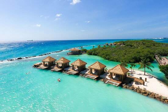 Luxurious Caribbean all-inclusive resort with turquoise water and cabanas