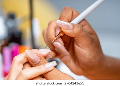 Nail technician carefully applying acrylic nails in a bright salon