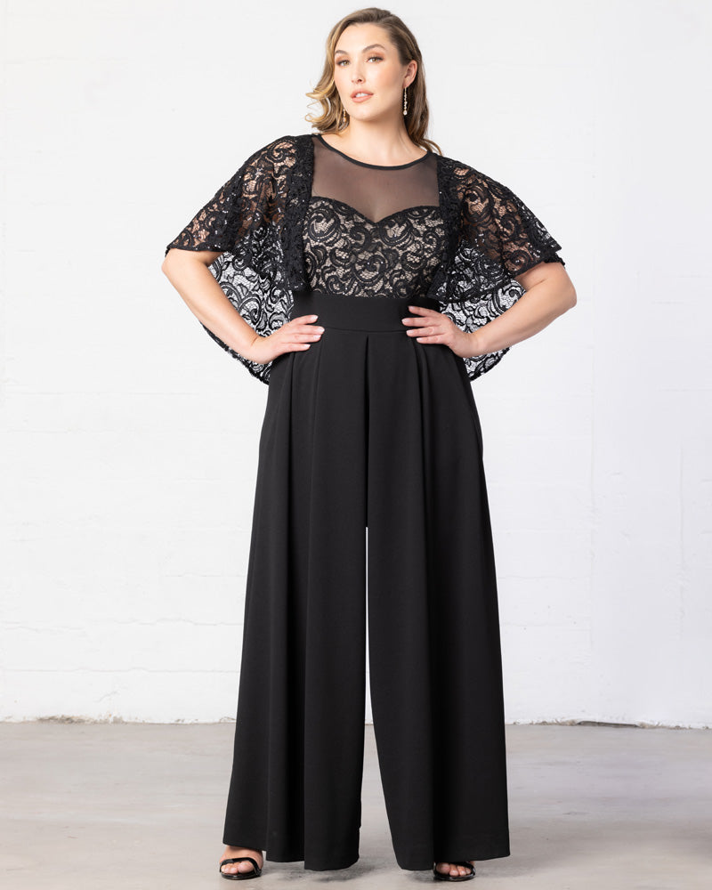 Plus-size woman in an elegant jumpsuit at an outdoor evening event with string lights