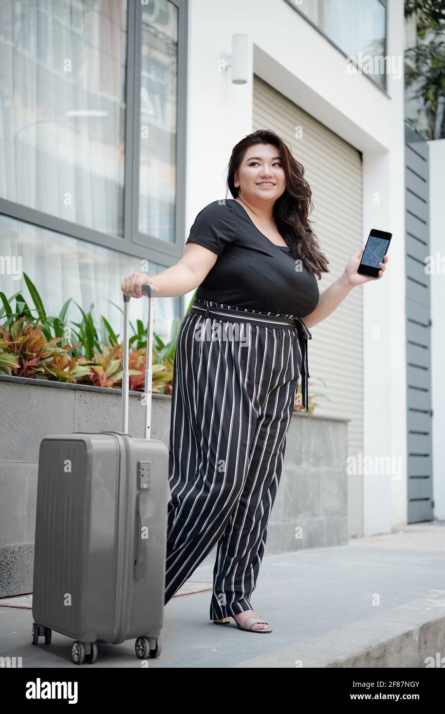Plus size woman walking through an airport ready to travel