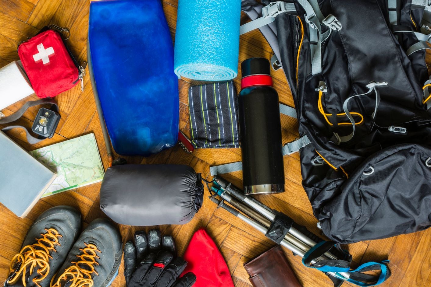Walking preparation essentials flat lay with shoes, water bottle, tracker, and notebook