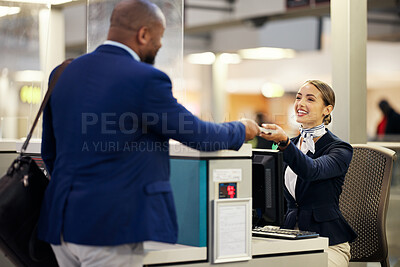Airline ticket counter agent helping a traveler check in at the airport