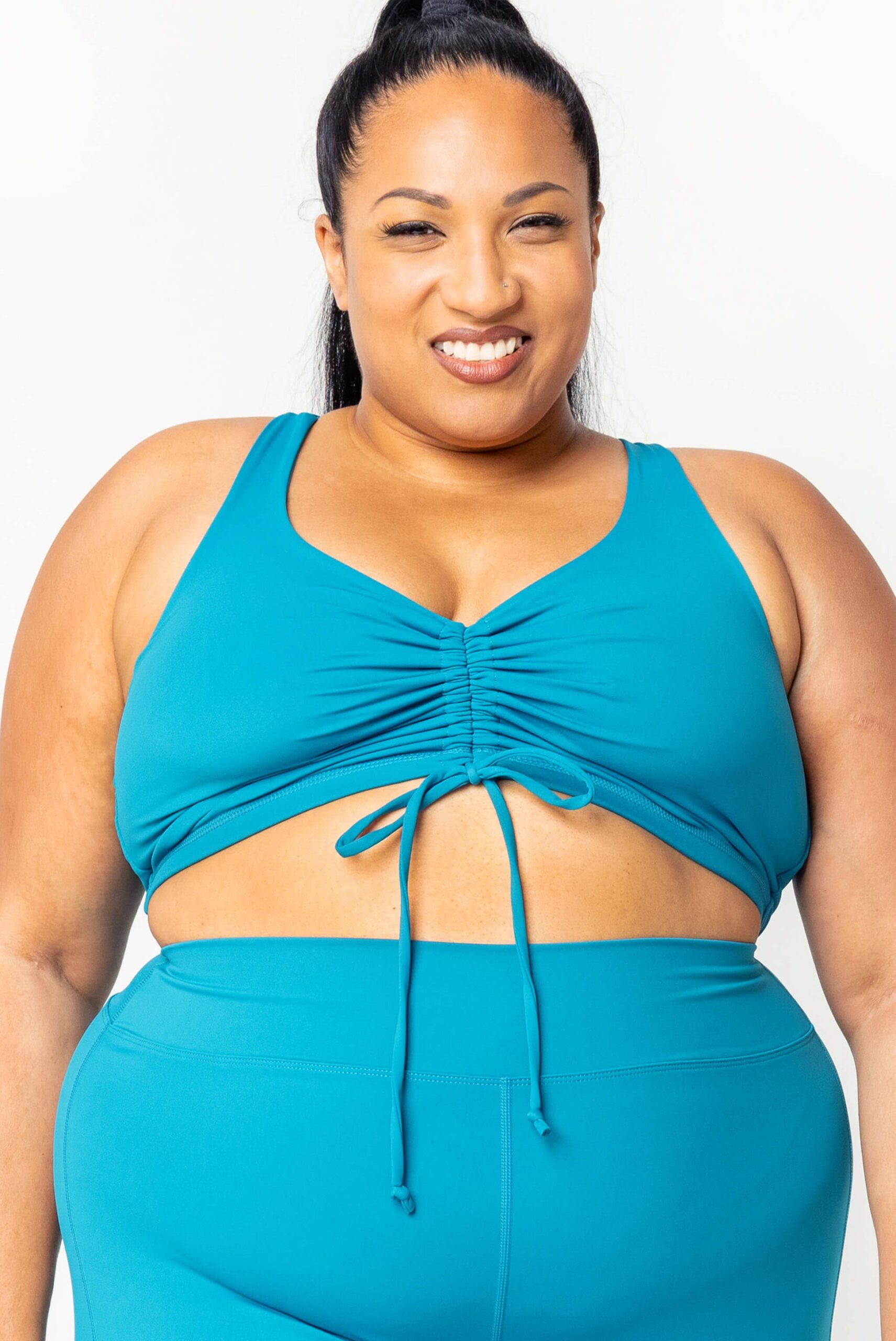 High waisted swim bottoms paired with a fitted swim top on a plus size body