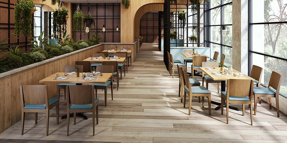 Interior of a restaurant showing a row of fixed booths beside movable tables and chairs