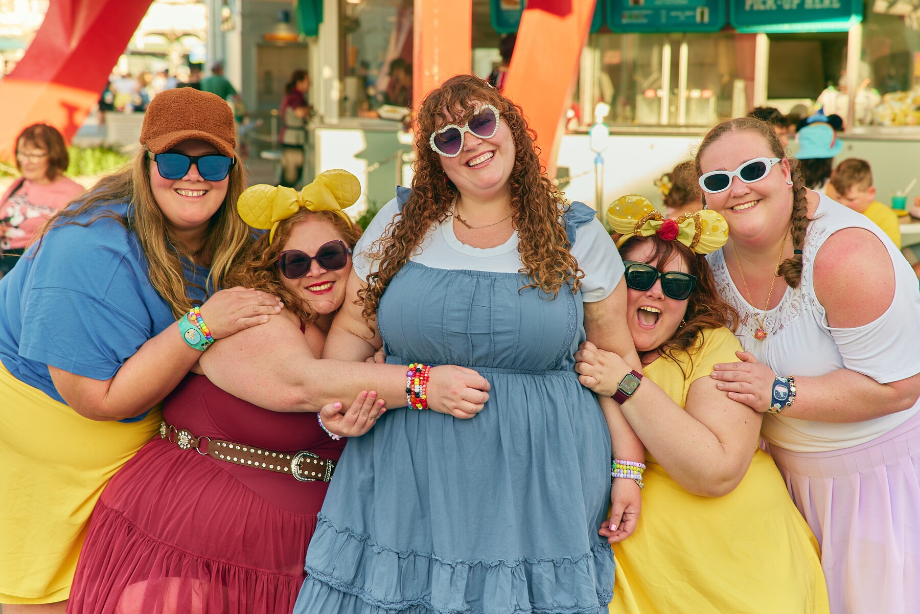 Plus size woman smiling in line at an amusement park on a bright summer day