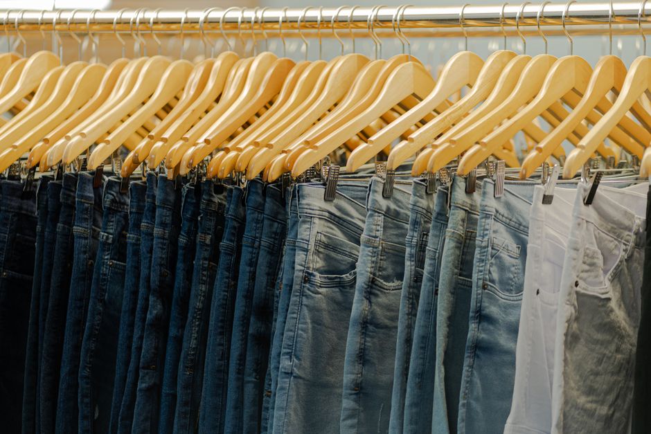 Rack of dark wash stretch denim jeans in a boutique