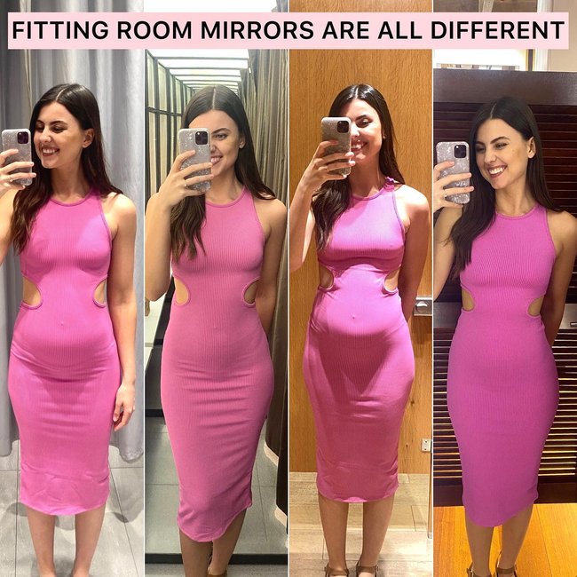 Woman comparing two garments in a fitting room mirror