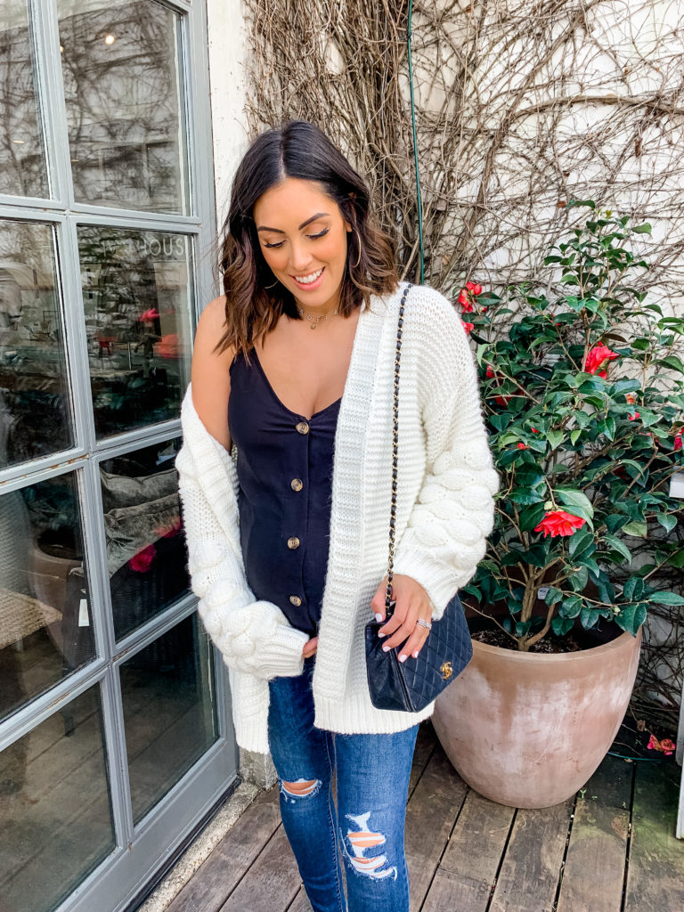 Woman wearing an open front cardigan over a simple tank top